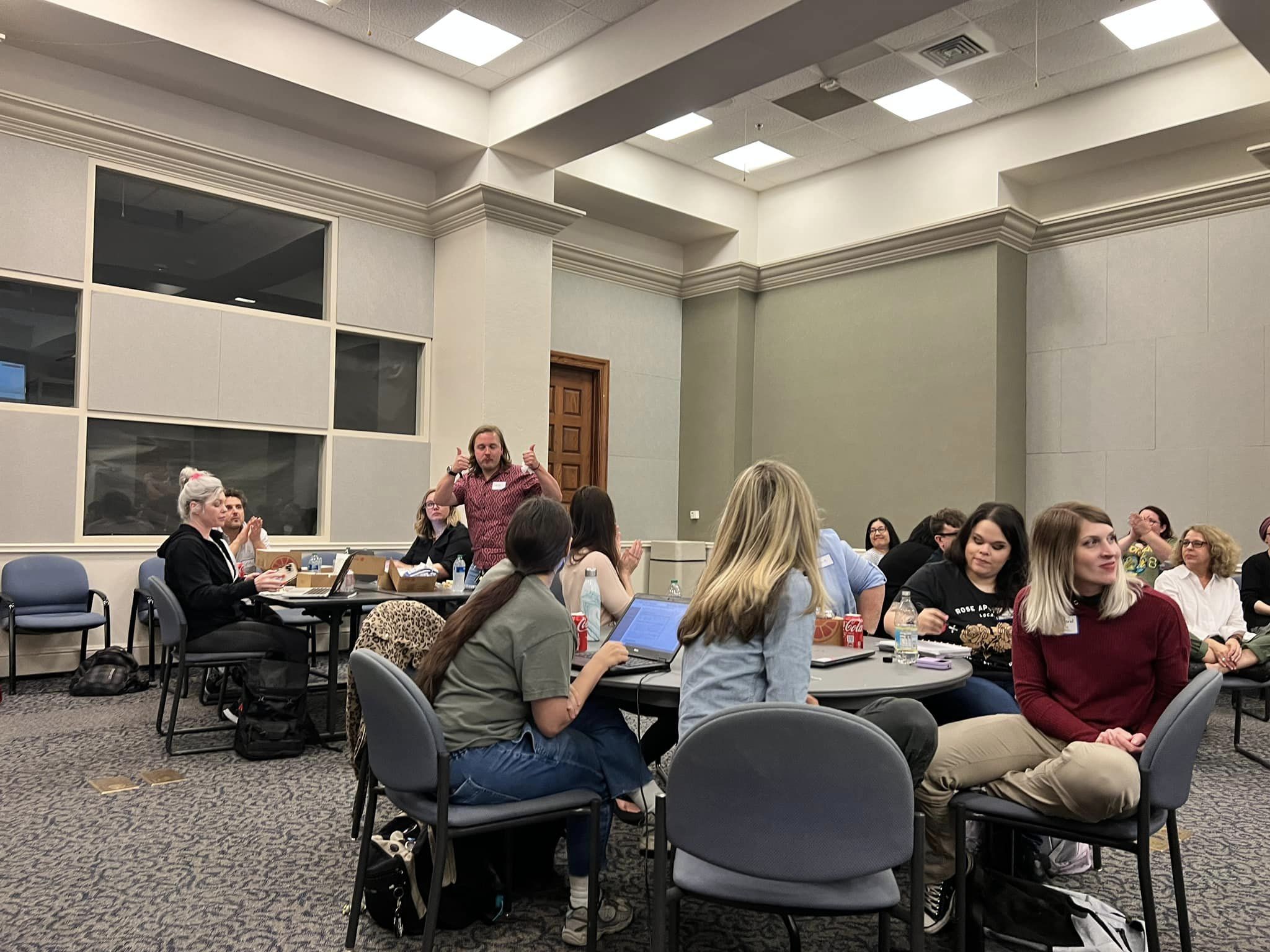Phd student gives a thumbs up in support at orientation