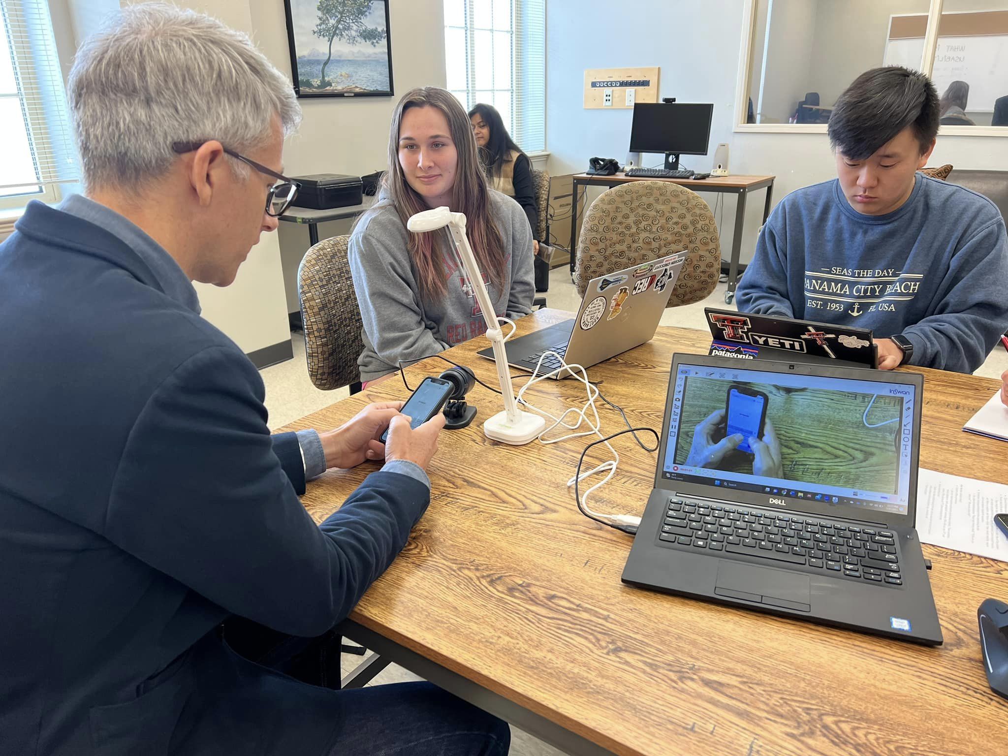 Dr. Rob Grace and students working with eye-tracking technology